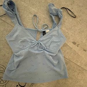 Very cute light blue summer tank. Ties in back.
